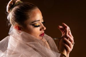 A graceful dancer adorned with striking snake jewelry, exuding elegance.